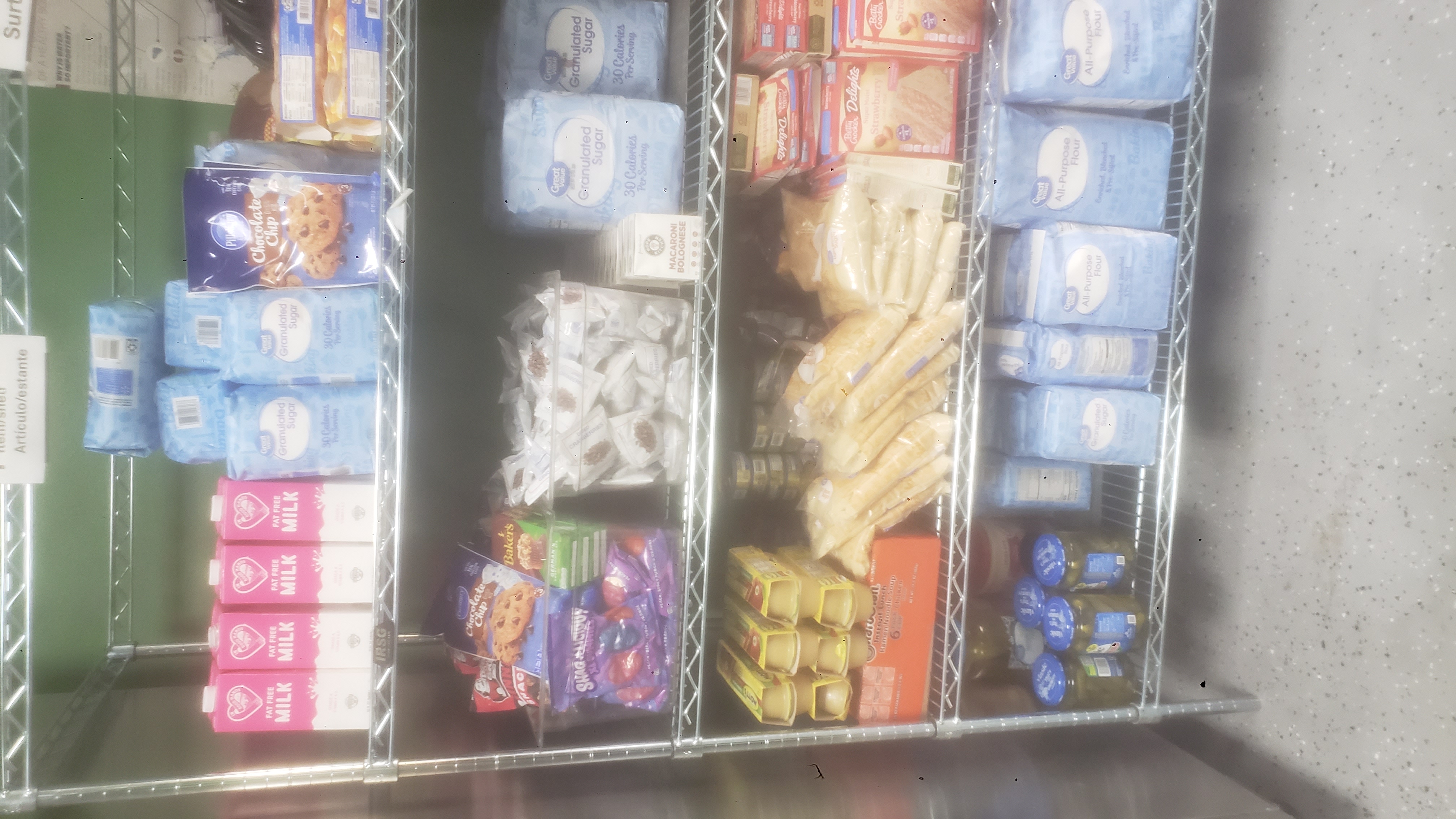 Shelves filled with food, ingredients, and milk.